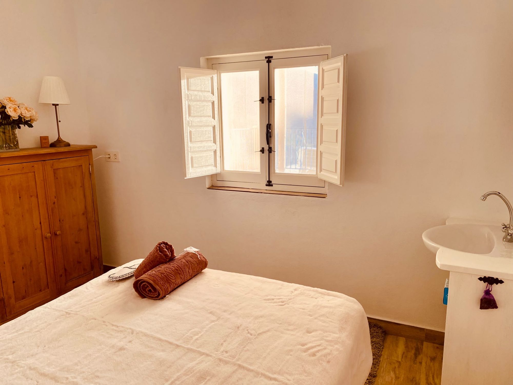 Bedroom with a wooden wardrobe and its own sink